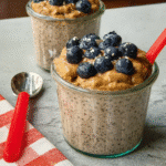 The Ultimate Protein Blueberry Peanut Butter Chia Pudding (Easy & Creamy) 10 creamy protein blueberry peanut butter chia pudding in a jar topped with blueberries and peanut butter