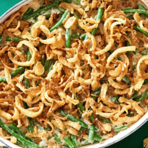 The Best Keto Green Bean Casserole Recipe 2 Overhead view of a festive holiday table featuring a creamy keto green bean casserole with a crispy golden-brown topping, surrounded by elegant place settings.
